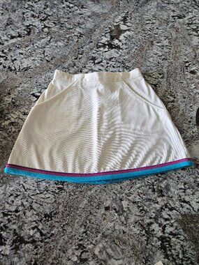 WOMEN'S WHITE TENNIS SKIRT WITH BLUE, PINK, AND PURPLE TRIM IN SIZE 7/8